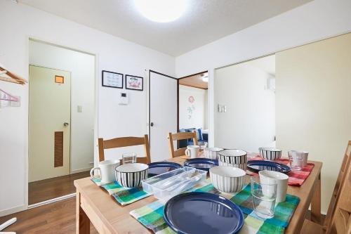 a dining room table with blue plates on it at Sun white Gyoutoku 303 in Tokyo