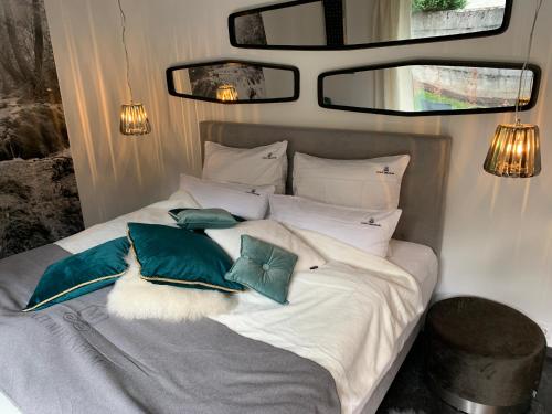 a bedroom with a bed with green and white pillows at Chalet Mirandum Apartments Vandans in Vandans