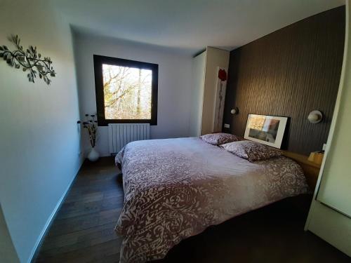 a bedroom with a large bed and a window at Holiday home De la Corniche in Annecy