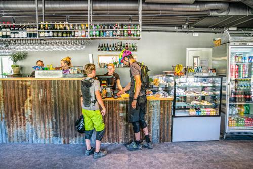 a man and a boy standing at a counter at JBP Hotell in Järvsö