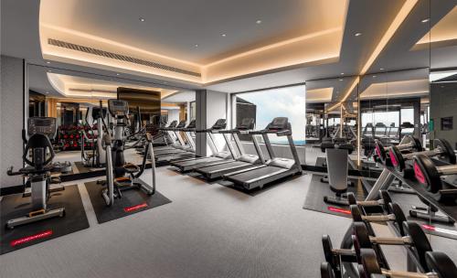 a gym with treadmills and elliptical machines at Hotel Indigo Taipei North by IHG in Taipei