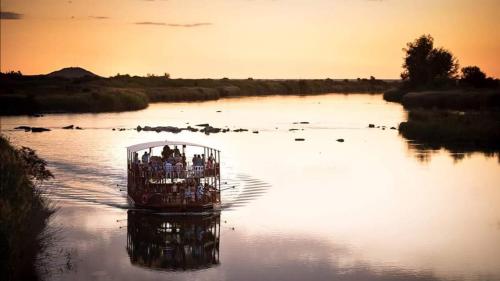 a group of people in a cage in the water at Moonriver Guesthouse in Upington
