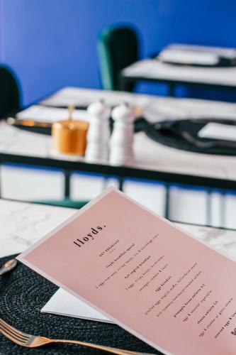 a table with a pink menu on a table at Pineapple House Boutique Hotel in Cape Town