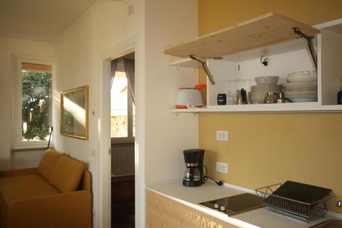 a kitchen with a counter and a chair in a room at Agriturismo Badalone in Domaso