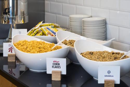 a counter with three bowls of food on a table at Holiday Inn Express Doncaster by IHG in Doncaster