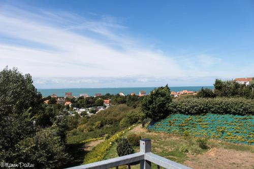 a view of a city from a hill with blue flowers at Hôtel Le Vivier WISSANT - Vue Mer - Côte d'Opale - Baie de Wissant - 2CAPS in Wissant