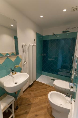 a bathroom with a sink and a toilet and a shower at Fattoria L'Olmetto in Pisa