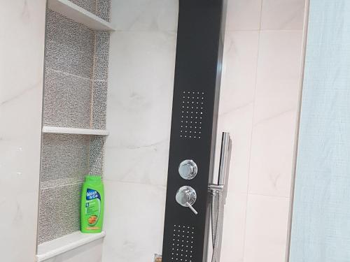 a shower with a black shower head in a bathroom at Ola Kala Apartments and Rooms in Vlikhon