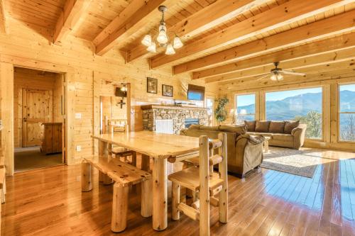 a kitchen and living room with a table in a cabin at Papa Bears Cabin in Gatlinburg