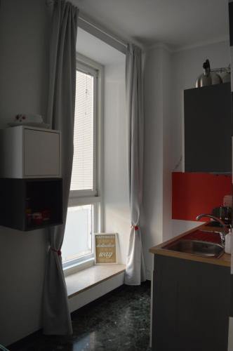 a kitchen with a window with a sink and a counter at Gio&Gio little house in Genoa