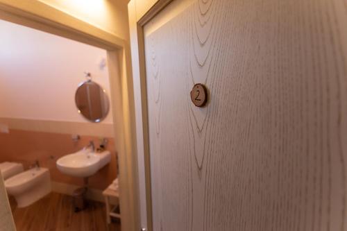a door leading to a bathroom with a sink at Fattoria L'Olmetto in Pisa