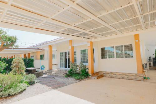 a building with awning over a courtyard at Glass House, Mountain View, Near Airport-City in Chiang Rai
