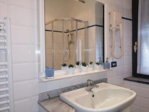 a bathroom with a sink and a shower at Lucky House in La Spezia