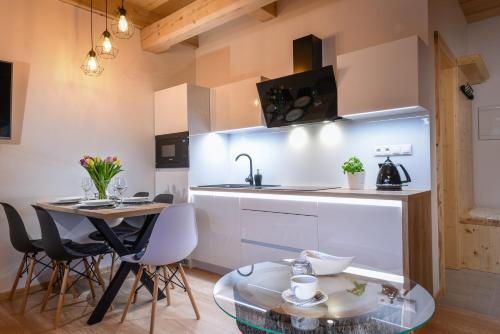 a kitchen with a table and a counter top at Malinovy Sen II in Habovka