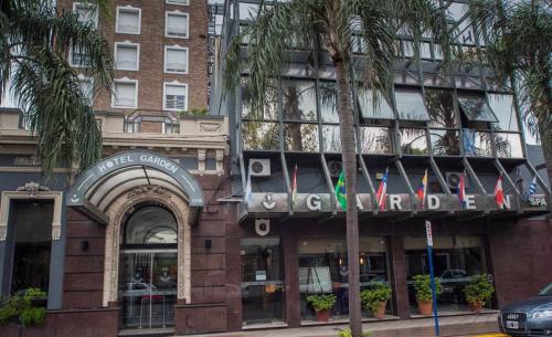 a facade of a building with flags in front of it at Hotel Garden in Rosario