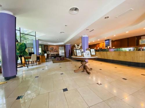 a teddy bear sitting on the floor of a lobby at Hotel Garden in Rosario