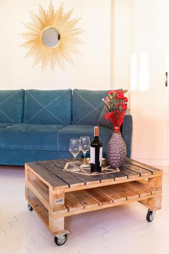 a coffee table with two wine glasses and a vase at Republika Kopernika Apartment in Toruń