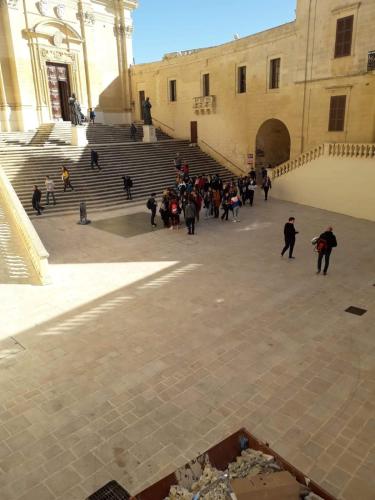 a group of people walking in front of a building at Cittadella b&b in Victoria