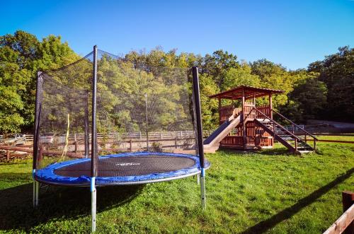 a playground with a slide and a swing set at Farma Ovčí Terasy in Němčičky
