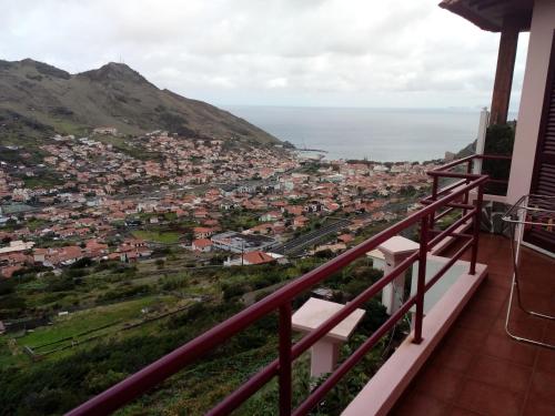 a view of a city from the balcony of a house at Moradia Cor de Rosa in Machico