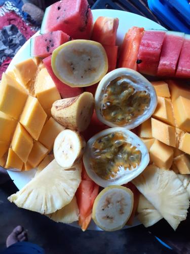 a plate of fruit and vegetables on a table at Turtle Reef Guest in Mirissa