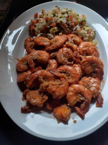 a plate of food with shrimp and a salad at Turtle Reef Guest in Mirissa