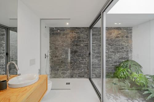 a bathroom with a shower and a sink at Casas da Vargem shared swimming pool by An Island Apart in Ponta do Sol