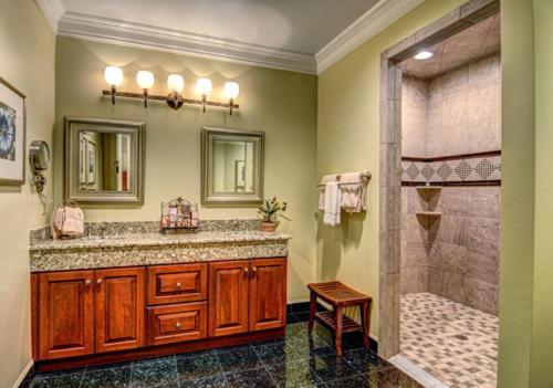 a bathroom with a shower and a sink and a tub at Cottages and Suites at River Landing in Wallace
