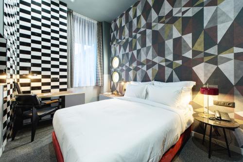 a hotel room with a bed and a desk at Stories Boutique Hotel in Budapest
