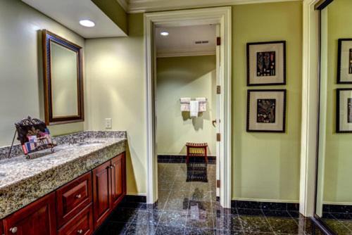 a bathroom with a sink and a mirror at Cottages and Suites at River Landing in Wallace
