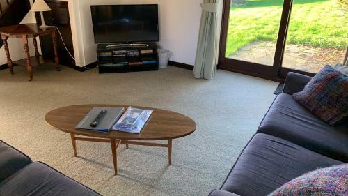 a living room with a couch and a coffee table at Hayloft Cottage - Dog Friendly With Private Garden in Sidmouth