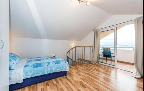 a bedroom with a blue bed and a balcony at Apartment Miro in Prvić Šepurine