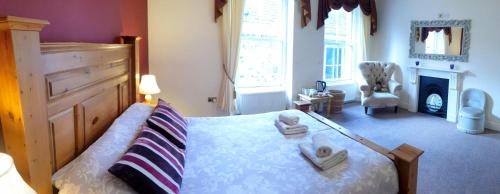 a bedroom with a bed with towels on it at Station House, Dartmoor and Coast located, Village centre Hotel in South Brent