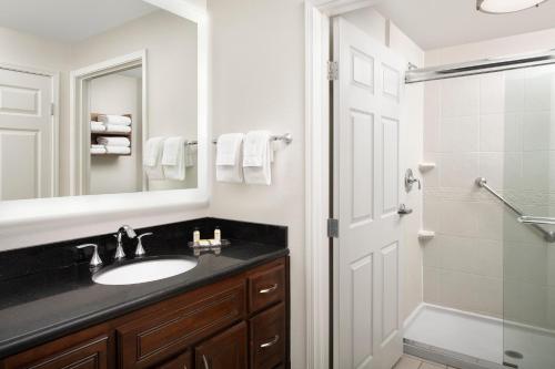 a bathroom with a sink and a shower and a mirror at Staybridge Suites Columbia, an IHG Hotel in Columbia