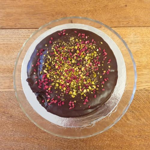 a chocolate doughnut with sprinkles on a plate on a table at Station House, Dartmoor and Coast located, Village centre Hotel in South Brent