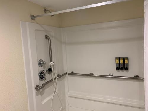 a bathroom with a shower with a hose on the wall at Best Western Plus - Columbia North East in Columbia