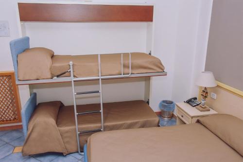 a room with two bunk beds and a bed at Hotel Piccolo Sogno in Pompei