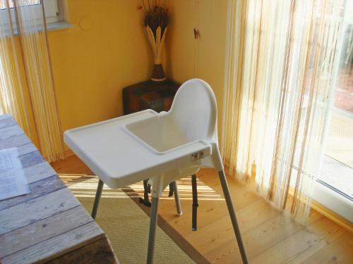 a white chair in a room with a window at Ferienhaus Anna Semmering in Semmering