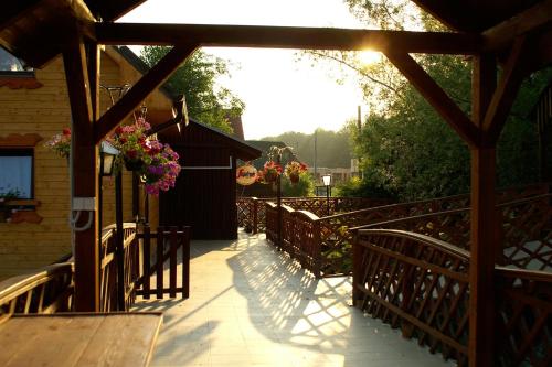 a wooden walkway with a fence and flowers at Chata ALBA REGIA in Jahodná