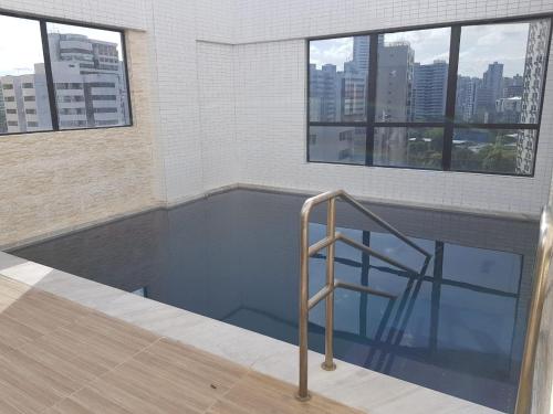 a swimming pool with a stair in a building at Ira's Home II in Recife