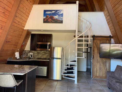 a kitchen with a spiral staircase in a cabin at Red Agave Resort in Sedona