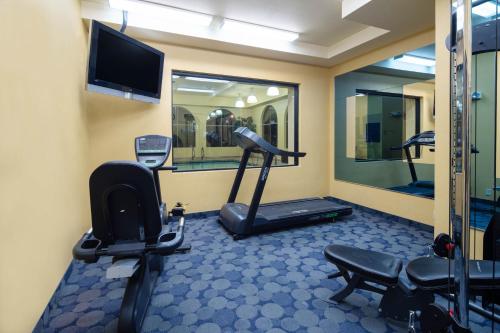 a room with a gym with a treadmill and a tv at Baymont by Wyndham Las Vegas South Strip in Las Vegas