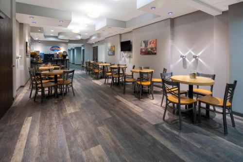 a dining room with wooden tables and chairs at Baymont by Wyndham Las Vegas South Strip in Las Vegas