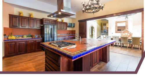 a large kitchen with a island in the middle at Villa El Retiro Luxury Property in Alajuela City