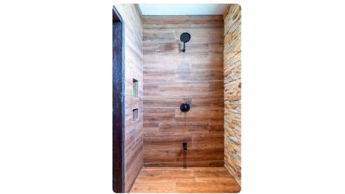a hallway with wooden walls and a wooden floor at Villa El Retiro Luxury Property in Alajuela City