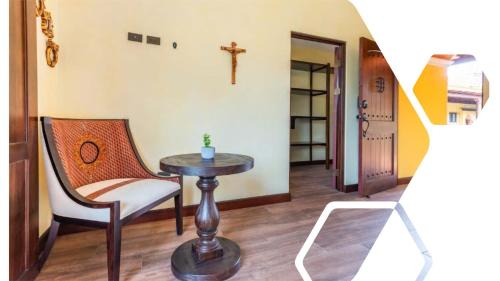 a room with a table and a chair and a cross on the wall at Villa El Retiro Luxury Property in Alajuela City
