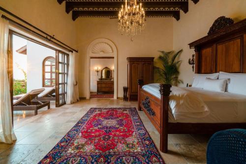 a bedroom with a bed and a rug on the floor at Casa Kimberly Boutique Hotel in Puerto Vallarta