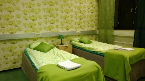 Un pat sau paturi într-o cameră la Motel Ruskalinna