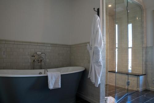 a bathroom with a bath tub and a shower at Public House Lofts in Crested Butte