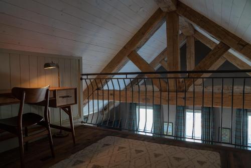 a loft bed with a desk and a chair in a room at Public House Lofts in Crested Butte